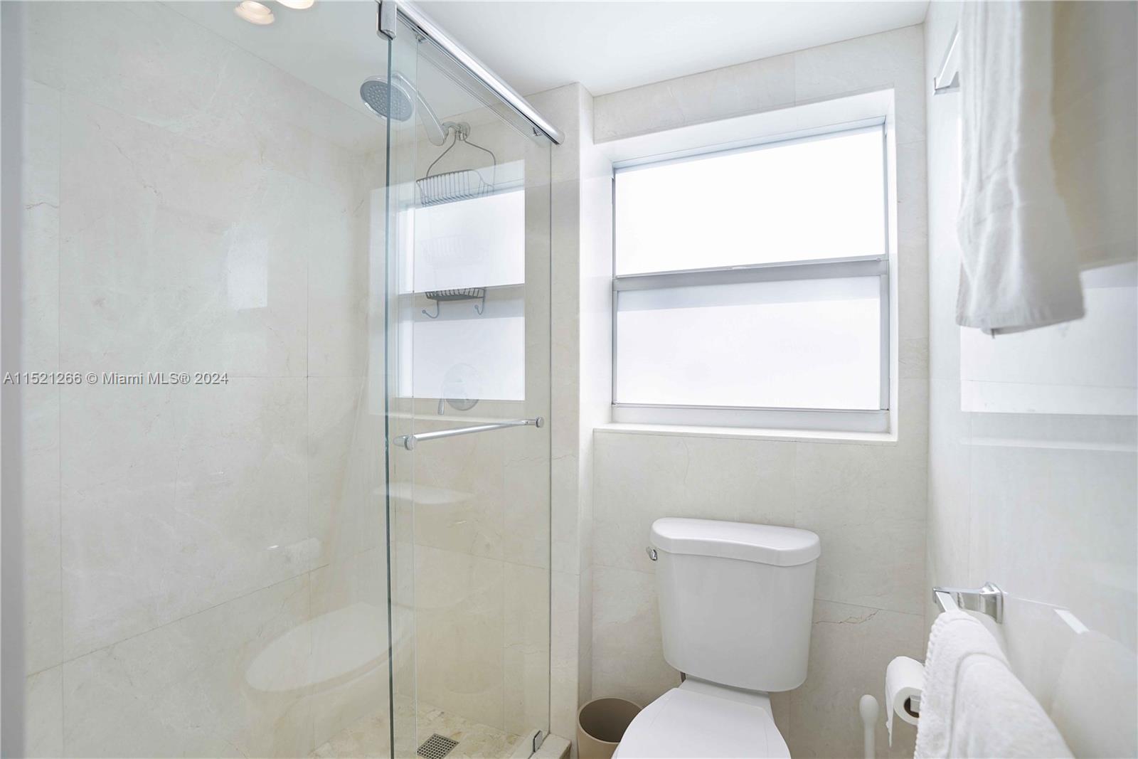 245 18th Street, Unit 902 Miami Beach, FL 33139 - Photo 47 of 54 a bathroom with a toilet and a shower