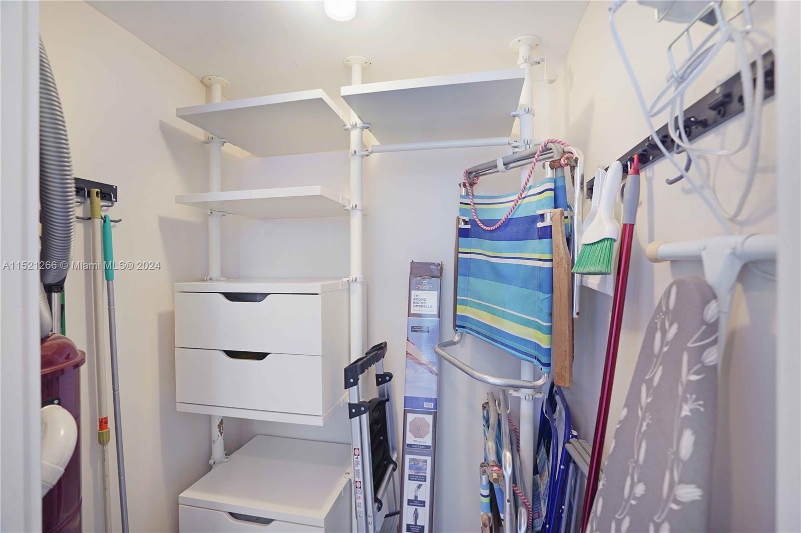 245 18th Street, Unit 902 Miami Beach, FL 33139 - Photo 49 of 54 a view of walk in closet with clothes and shoes