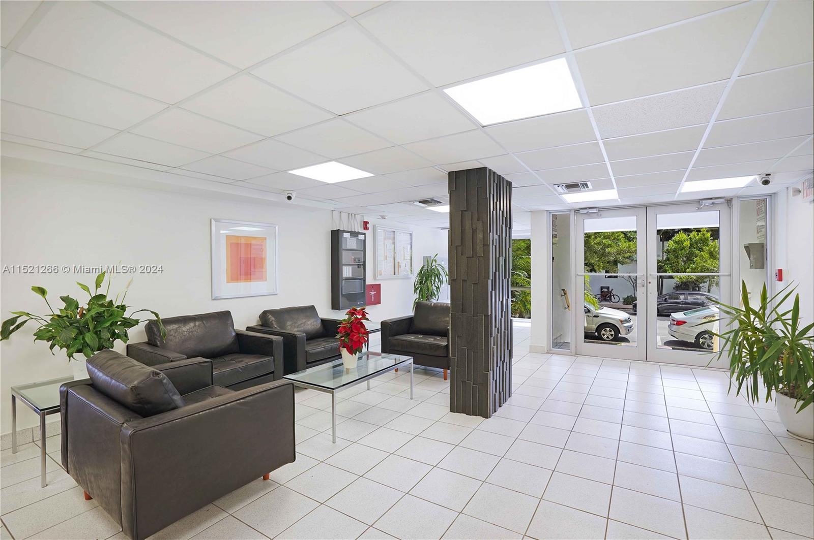245 18th Street, Unit 902 Miami Beach, FL 33139 - Photo 50 of 54 a living room with furniture and a potted plant
