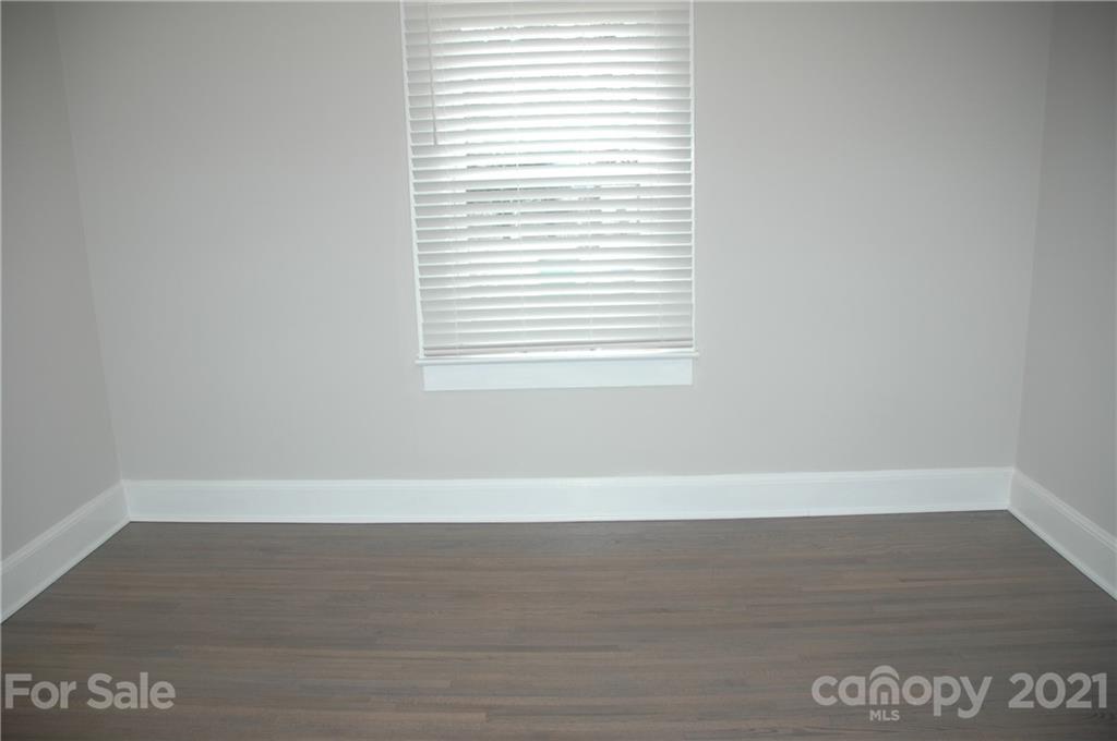 521 Gray Drive Charlotte, NC 28213 - Photo 12 of 34 a view of an empty room with wooden floor and a window