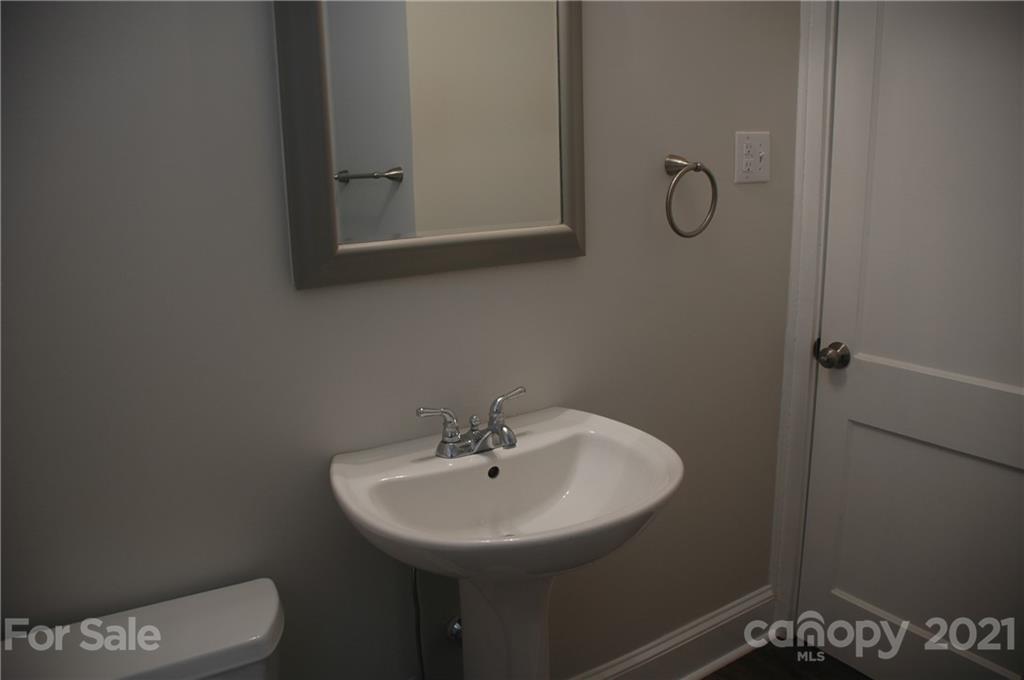 521 Gray Drive Charlotte, NC 28213 - Photo 15 of 34 a bathroom with a sink a toilet and a mirror