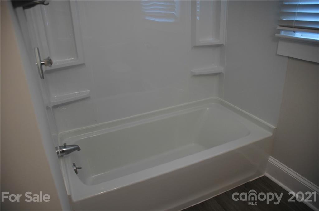 521 Gray Drive Charlotte, NC 28213 - Photo 16 of 34 a close up of a bathtub