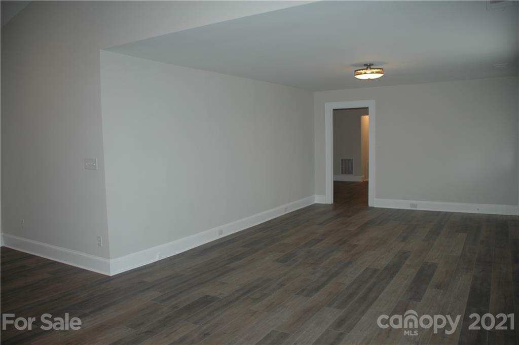 521 Gray Drive Charlotte, NC 28213 - Photo 22 of 34 a view of an empty room with wooden floor