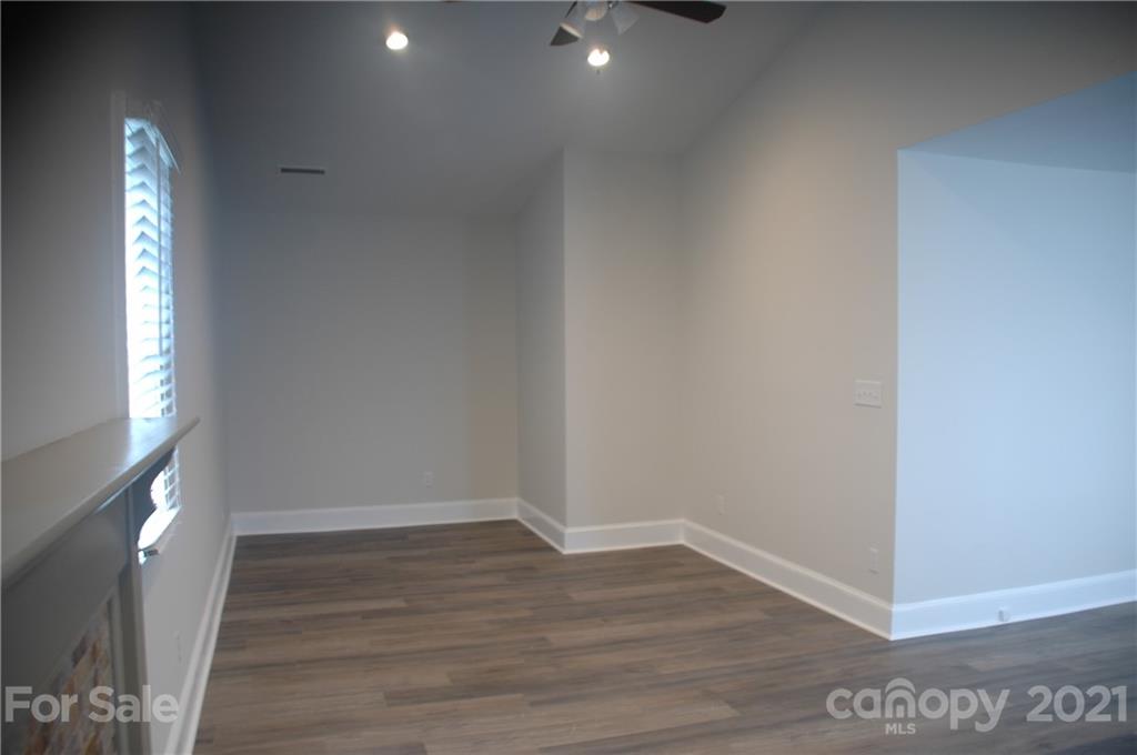 521 Gray Drive Charlotte, NC 28213 - Photo 23 of 34 a view of an empty room with wooden floor and a window