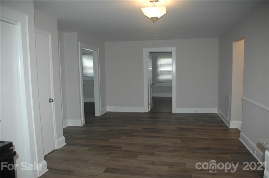 521 Gray Drive Charlotte, NC 28213 - Photo 6 of 34 a view of an empty room with wooden floor and a window