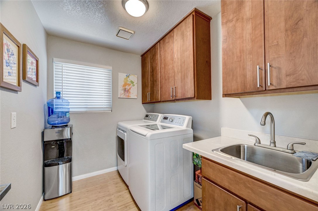 2600 Frontera Road Henderson, NV 89074 - Photo 22 of 47 Separate laundry room with cabinets and sink and window!