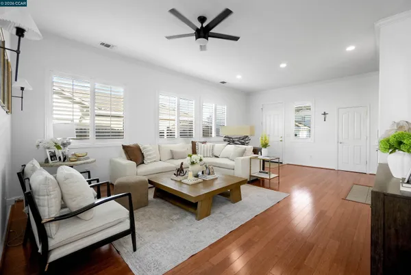 a living room with furniture and wooden floor