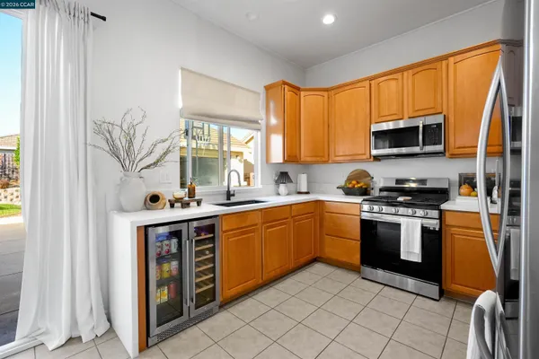a kitchen with stainless steel appliances granite countertop a stove top oven a sink and dishwasher