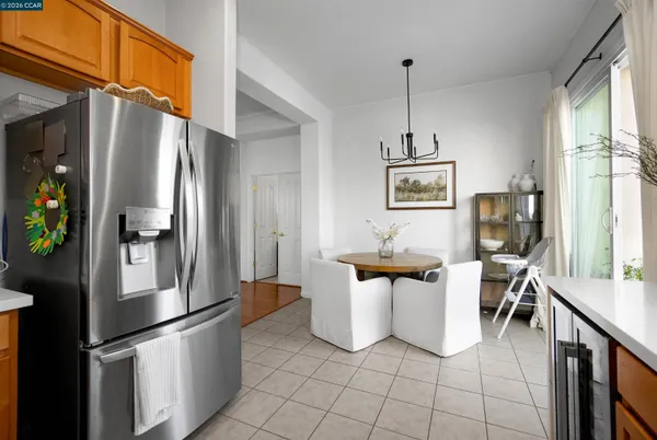 a kitchen with stainless steel appliances granite countertop a refrigerator a sink a stove and a refrigerator
