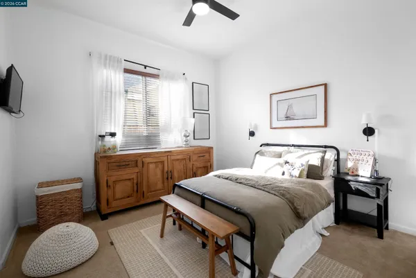 a bedroom with a bed a desk and chair