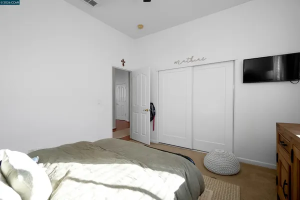 a bedroom with a bed and a flat screen tv