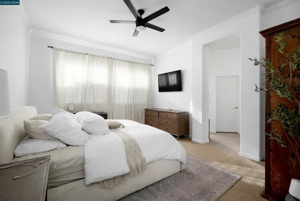 a bedroom with a bed and a television