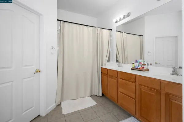 a bathroom with a double vanity sink and a mirror