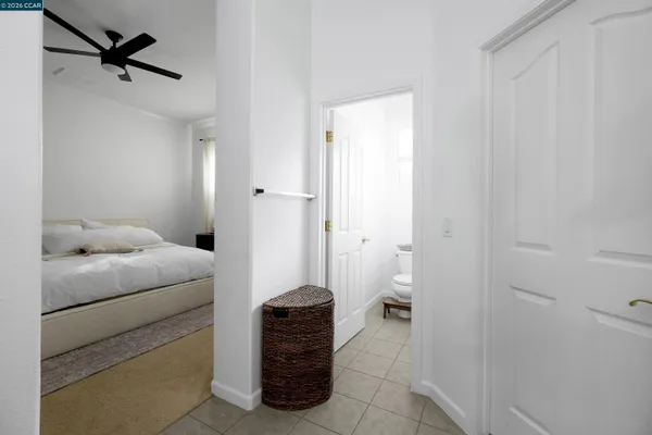 a room with a furniture and a ceiling fan