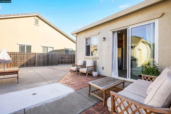a living room with furniture a table and a potted plant