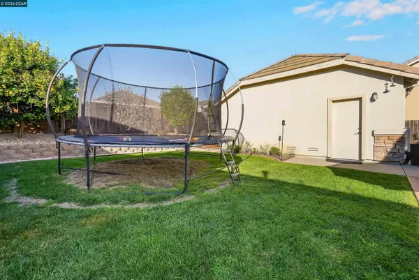 a view of backyard with a garden and deck