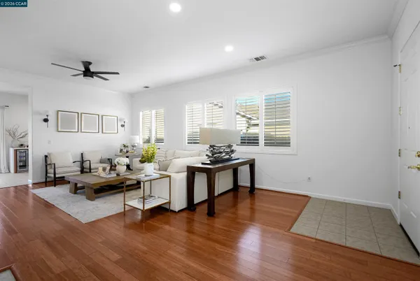 a living room with furniture and wooden floor