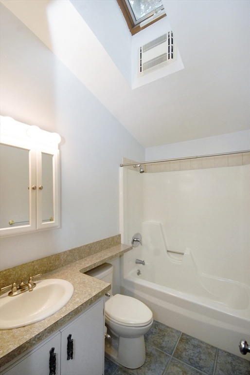 869 Burroughs Road Boxborough, MA 01719 - Photo 13 of 19 a bathroom with a granite countertop sink a toilet and a bathtub