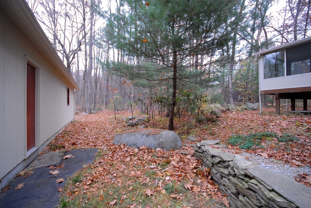 869 Burroughs Road Boxborough, MA 01719 - Photo 17 of 19 a backyard of a house with lots of green space