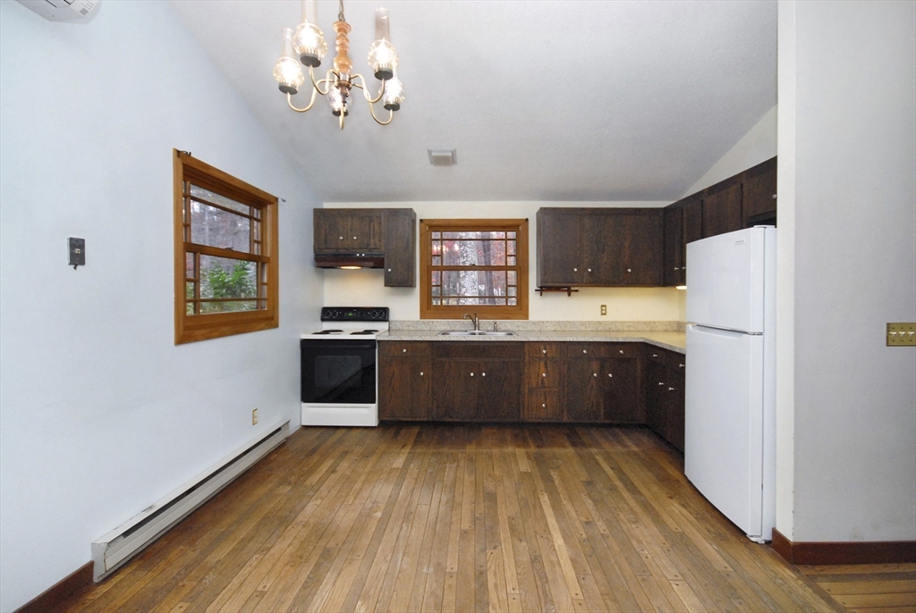 869 Burroughs Road Boxborough, MA 01719 - Photo 6 of 19 a large kitchen with a wooden floor and stainless steel appliances