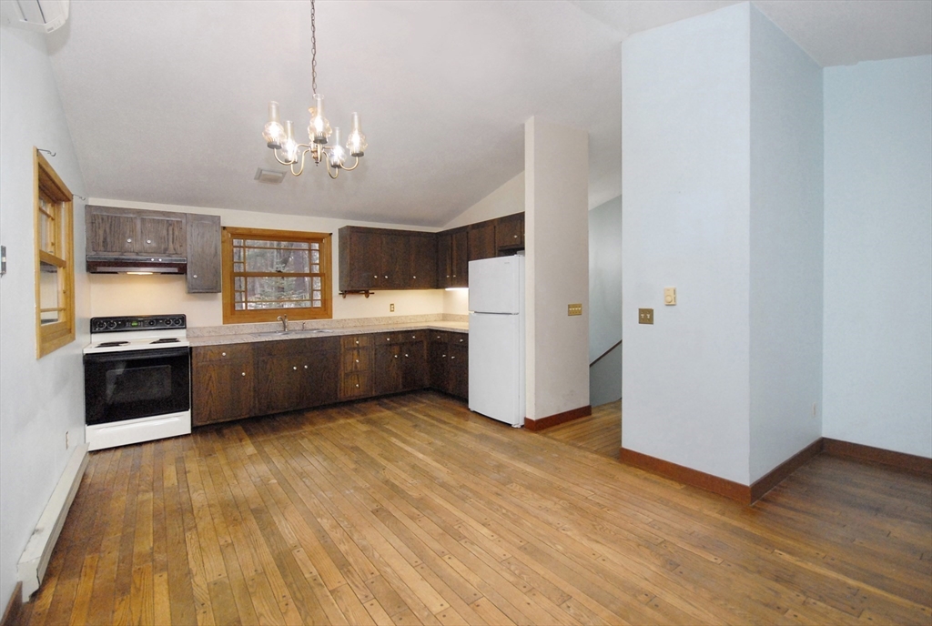869 Burroughs Road Boxborough, MA 01719 - Photo 7 of 19 a view of a kitchen with a sink and dishwasher a refrigerator with wooden floor