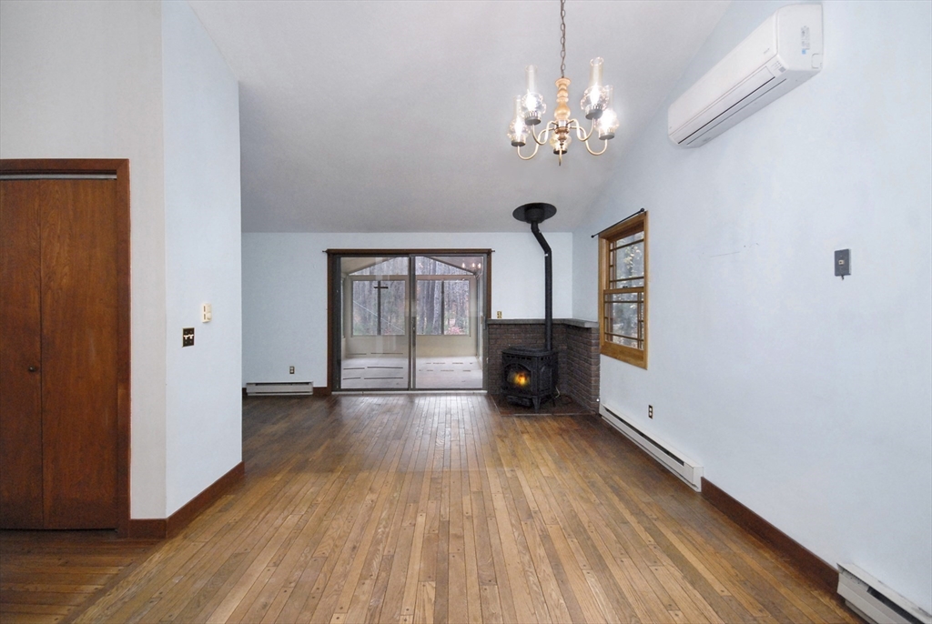 869 Burroughs Road Boxborough, MA 01719 - Photo 8 of 19 a view of an empty room with a window and wooden floor
