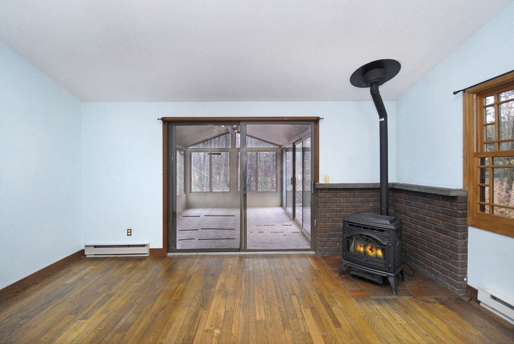 869 Burroughs Road Boxborough, MA 01719 - Photo 9 of 19 a view of empty room with wooden floor and fan