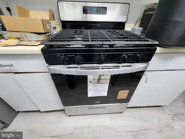 a stove top oven sitting inside of a kitchen