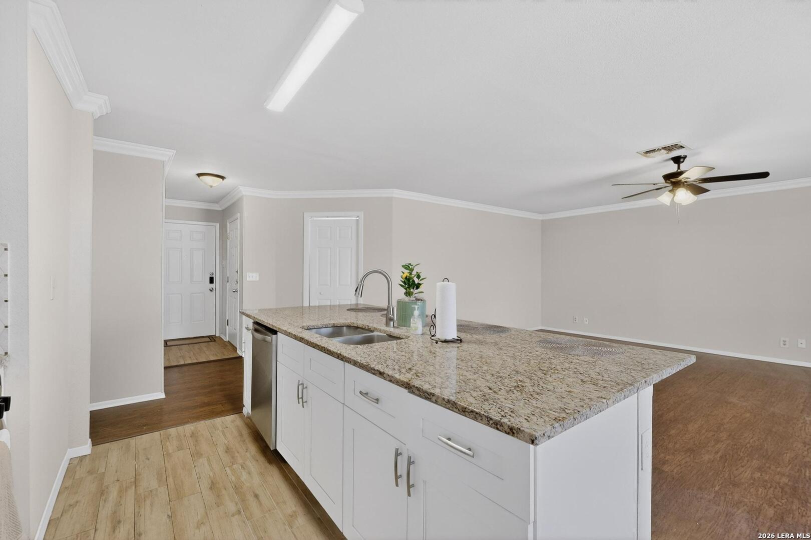 7219 Spring Drops Street San Antonio, TX 78249 - Photo 12 of 37 a kitchen with stainless steel appliances granite countertop a sink dishwasher and stove