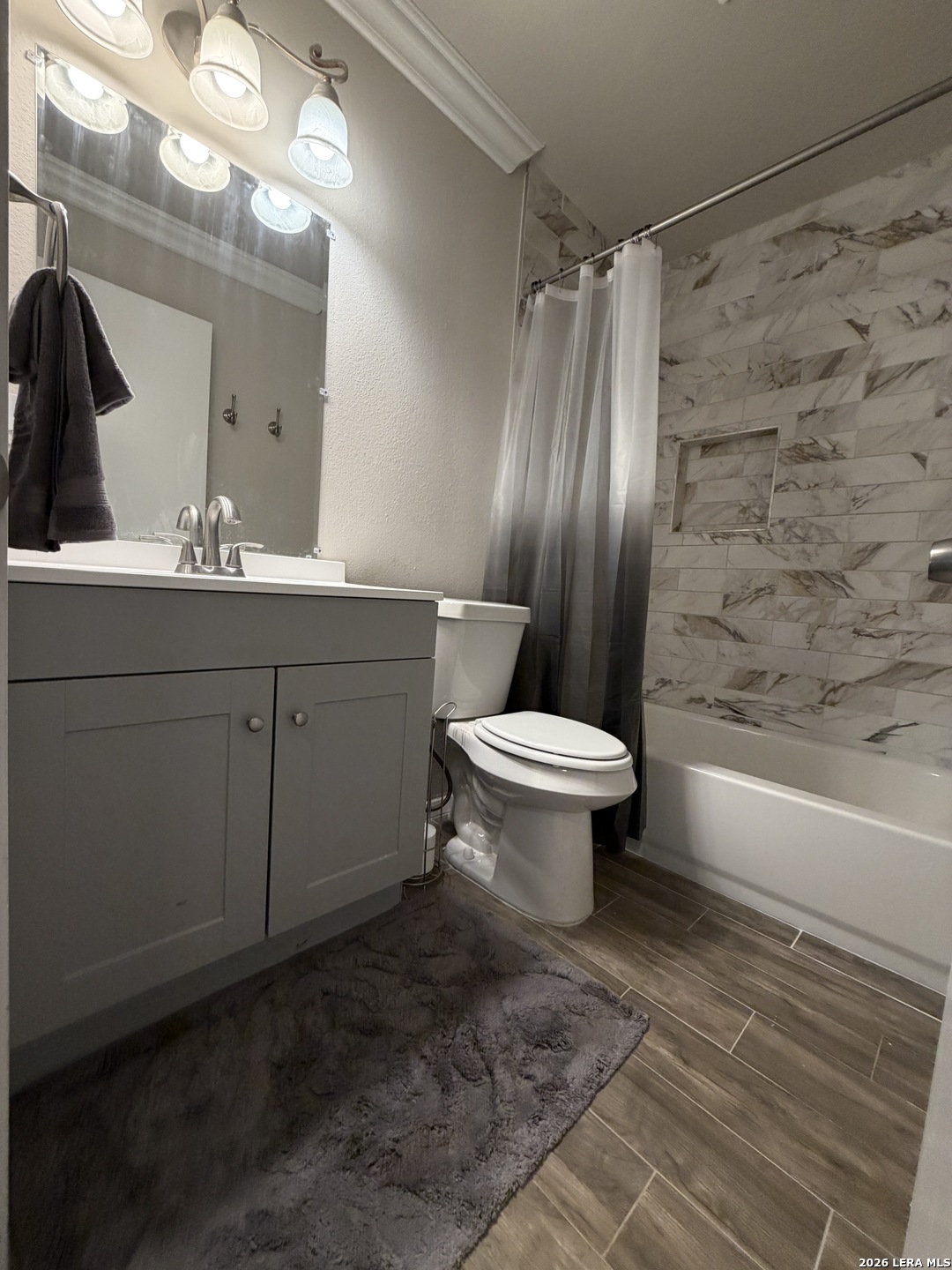 7219 Spring Drops Street San Antonio, TX 78249 - Photo 26 of 37 a bathroom with a sink toilet and shower