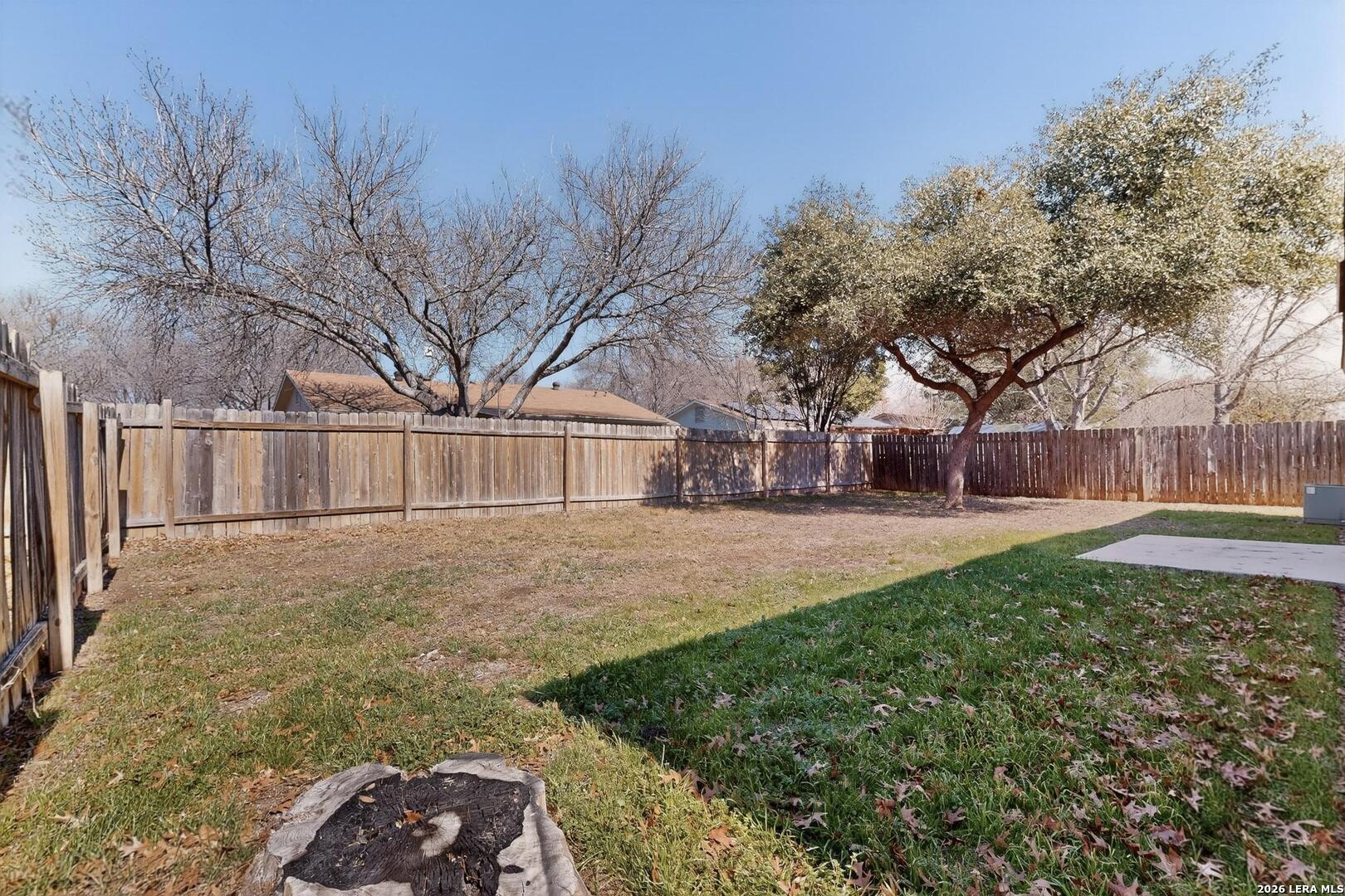 7219 Spring Drops Street San Antonio, TX 78249 - Photo 34 of 37 a view of a yard with a house and trees in the background