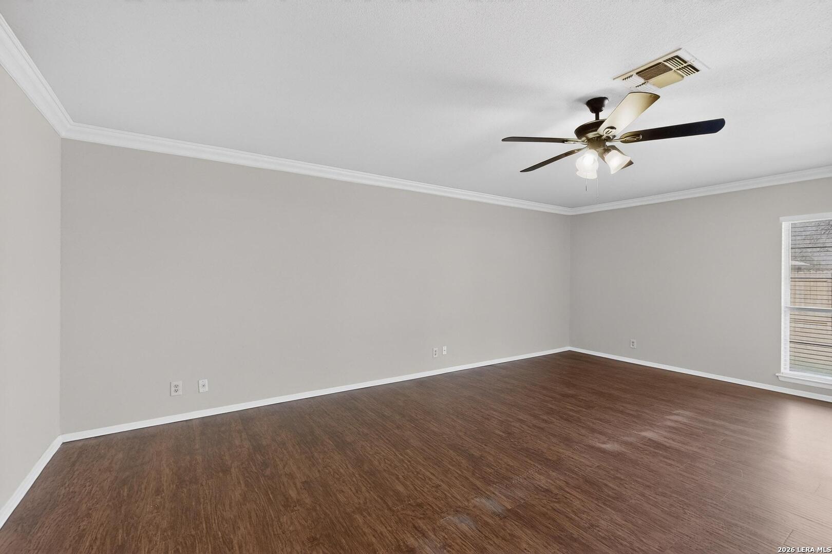 7219 Spring Drops Street San Antonio, TX 78249 - Photo 6 of 37 a view of a room with wooden floor and a ceiling fan