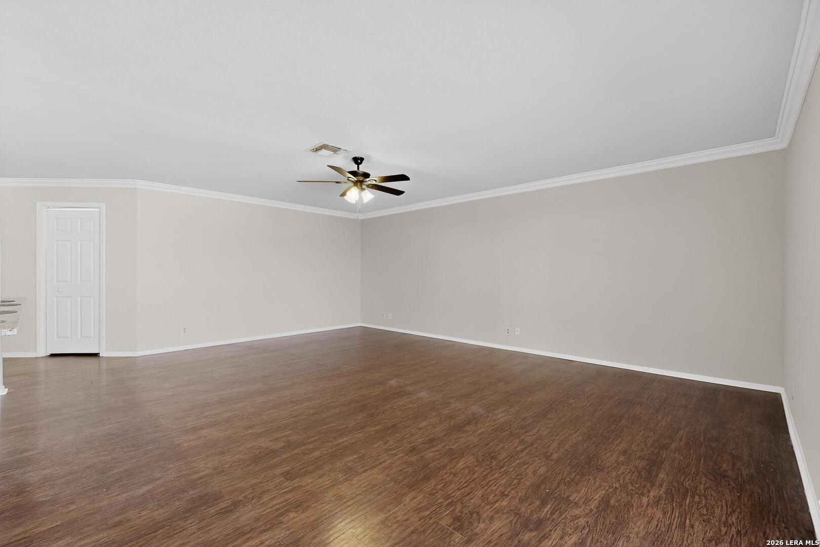 7219 Spring Drops Street San Antonio, TX 78249 - Photo 7 of 37 a view of an empty room with wooden floor and chandelier fan