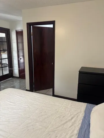 a bedroom with a bed and a mirror