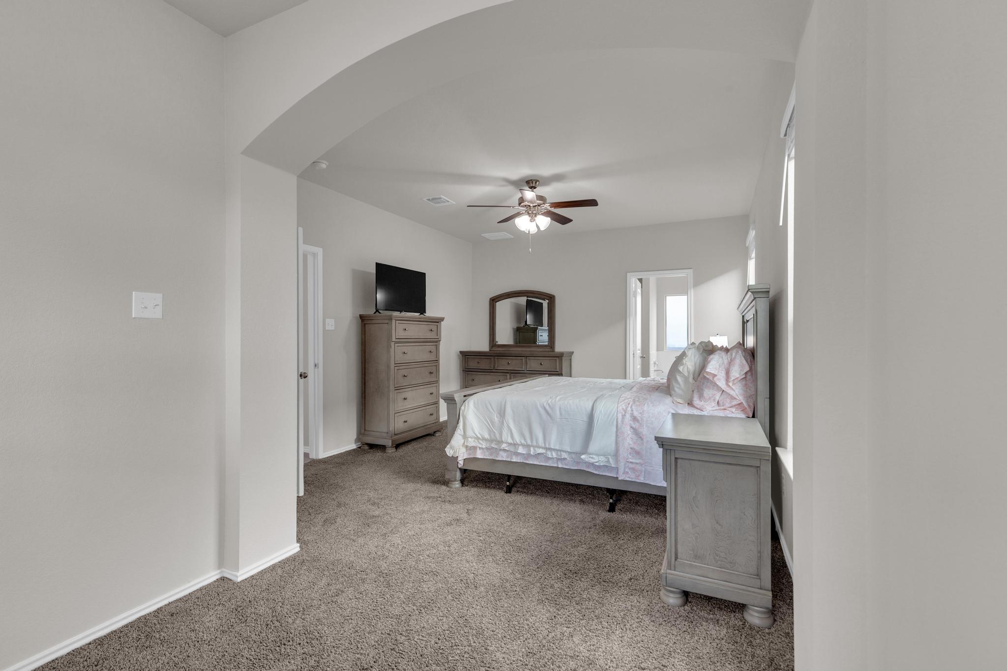 104 Uncle Billy Way Jarrell, TX 76537 - Photo 5 of 38 Relax in comfort in this naturally illuminated bedroom, offering plush carpeting and an overhead ceiling fan.