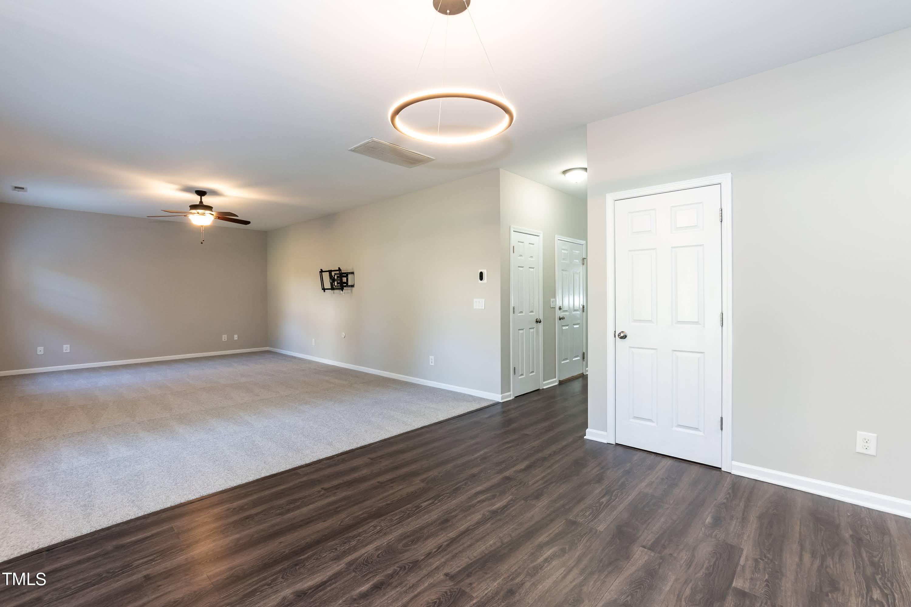 408 Cottesbrook Drive Wake Forest, NC 27587 - Photo 11 of 37 an empty room with wooden floor and windows