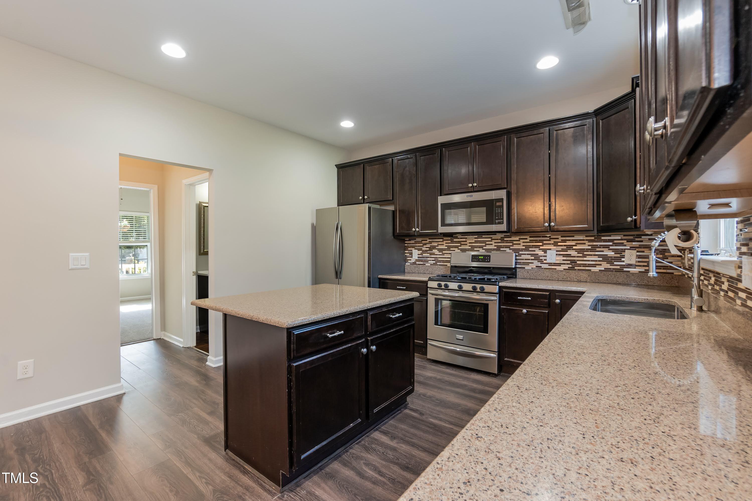 408 Cottesbrook Drive Wake Forest, NC 27587 - Photo 14 of 37 a kitchen with a stove a sink and a microwave