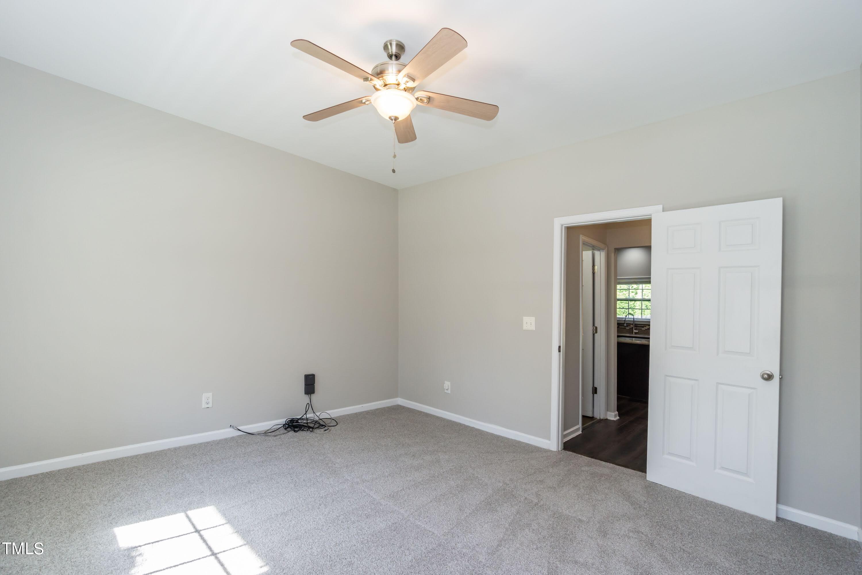 408 Cottesbrook Drive Wake Forest, NC 27587 - Photo 15 of 37 an empty room with a ceiling fan and a window