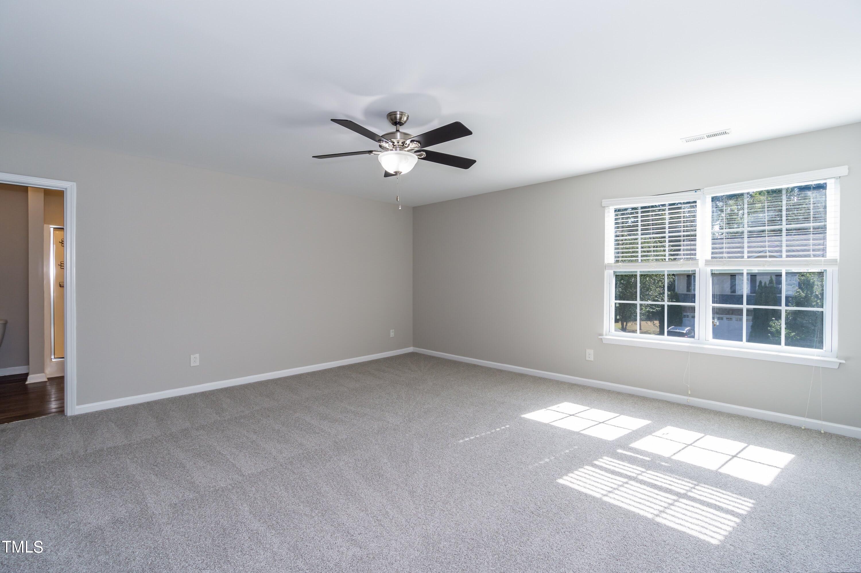 408 Cottesbrook Drive Wake Forest, NC 27587 - Photo 20 of 37 an empty room with windows and ceiling fan