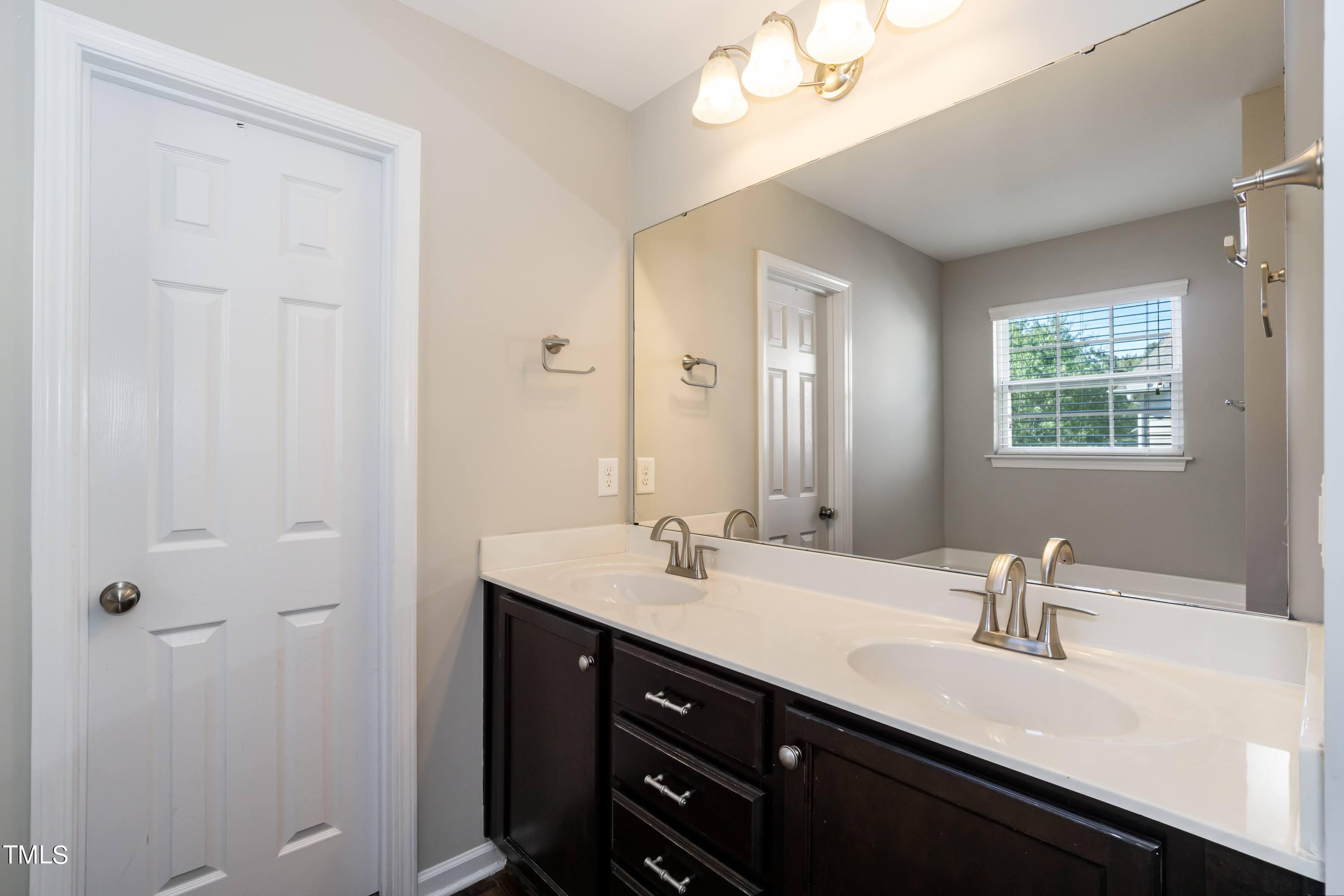408 Cottesbrook Drive Wake Forest, NC 27587 - Photo 21 of 37 a bathroom with a double vanity sink and a mirror