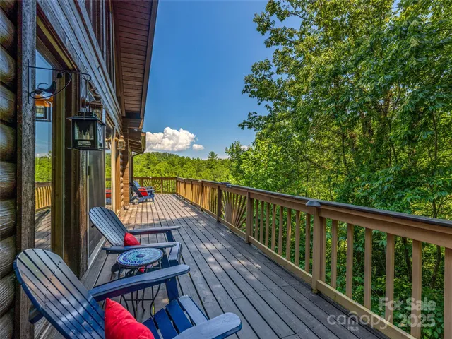 a view of balcony with wooden floor and outdoor seating