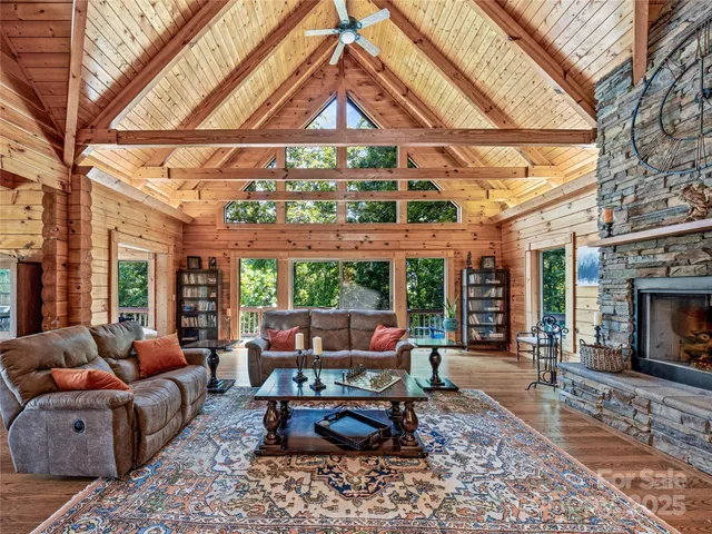 a living room with furniture a fireplace and a ceiling fan