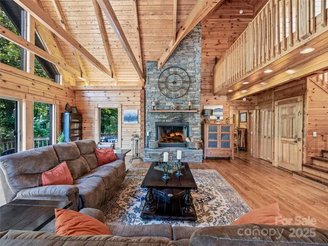 a living room with furniture a fireplace and a large window