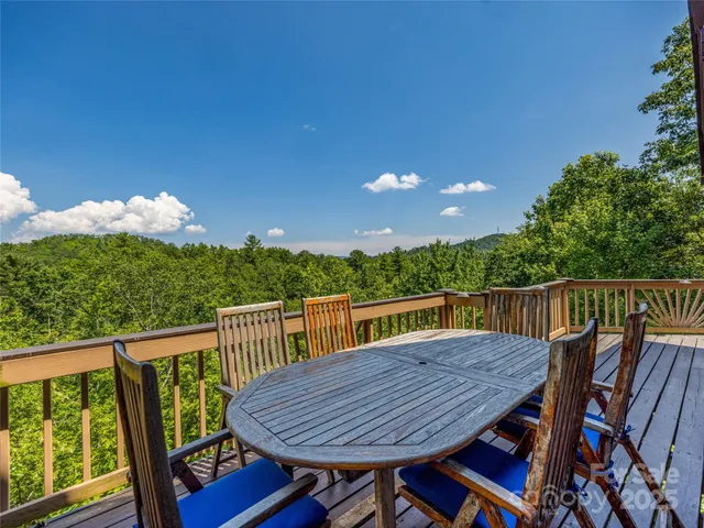 a view of a deck with wooden floor and outdoor seating