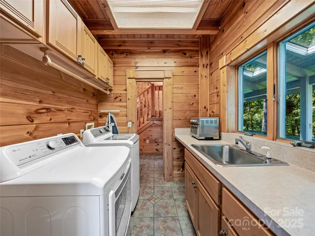 a utility room with sink dryer and washer