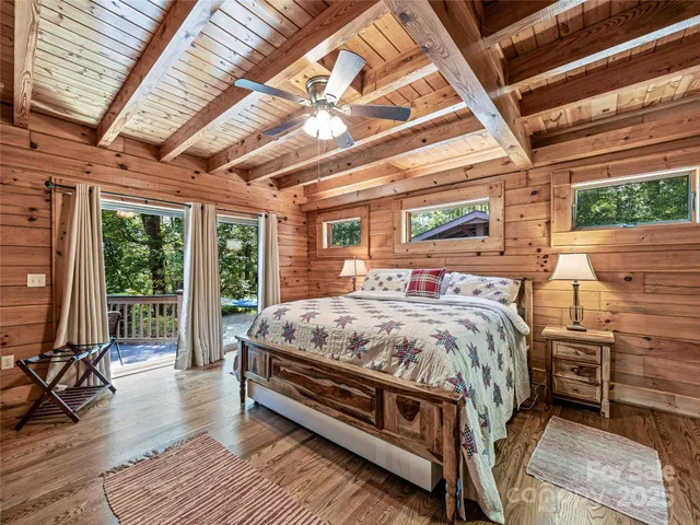 a bed sitting in a spacious bedroom next to a window