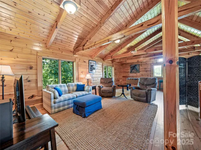 a living room with furniture fireplace and a large window