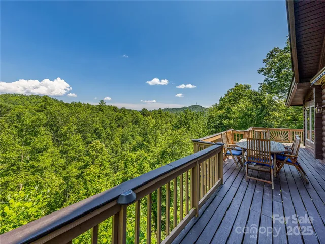 a view of balcony with wooden floor and outdoor seating