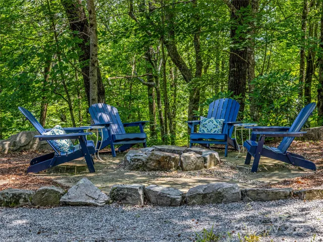 a view of a chairs and table in the backyard