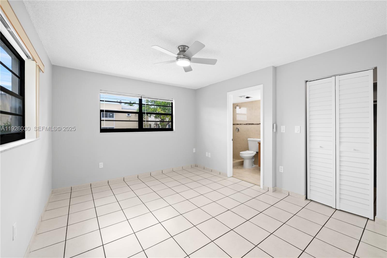 7915 Harding Avenue, Unit 1 Miami Beach, FL 33141 - Photo 14 of 25 a view of an empty room with window and cabinet